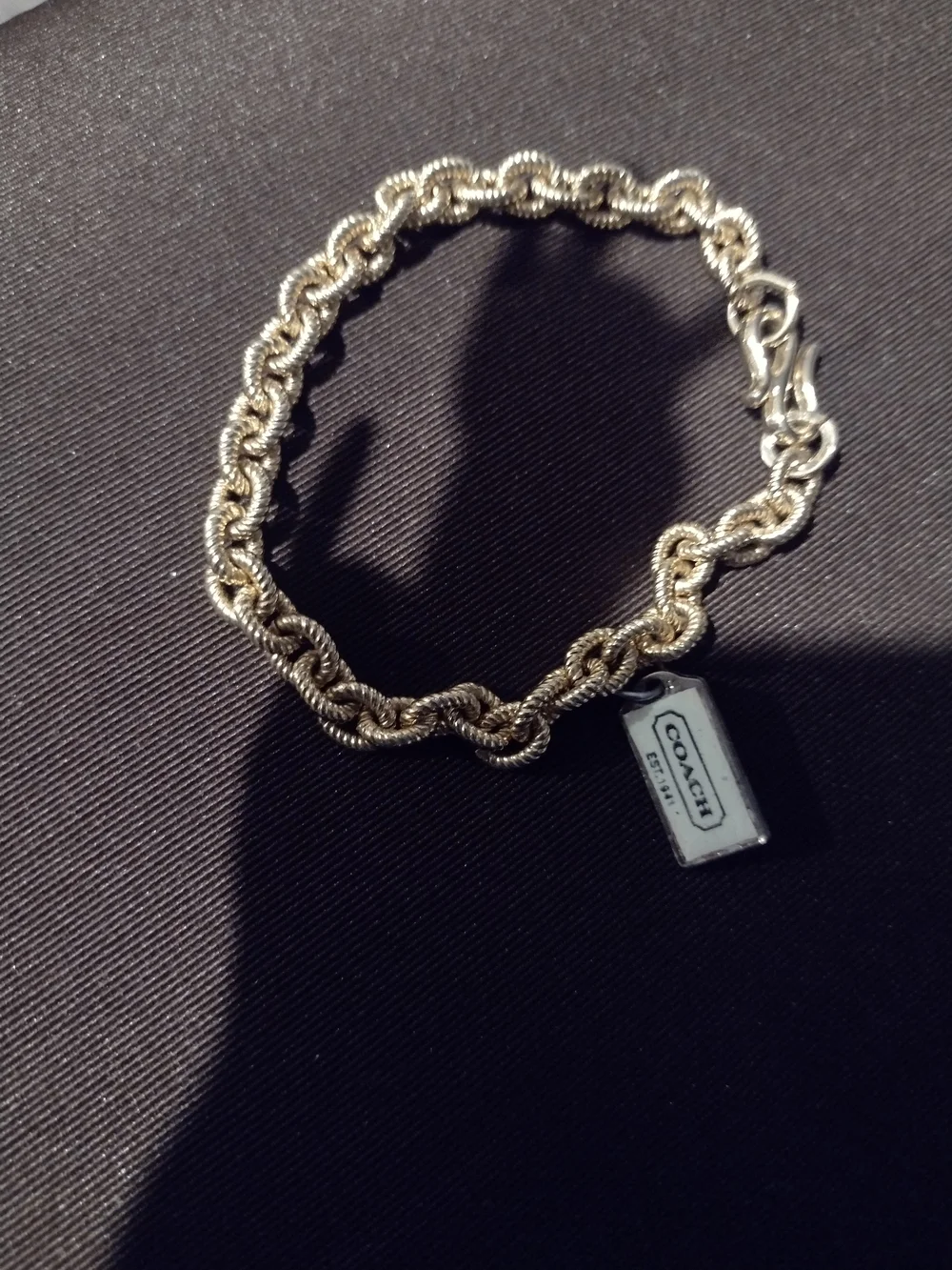 Coach Gold-Tone Twisted Rope Chain Bracelet with Logo Tag